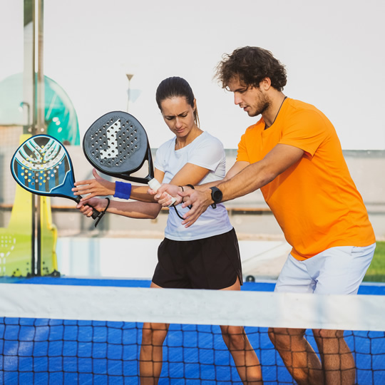 People learning to play padel