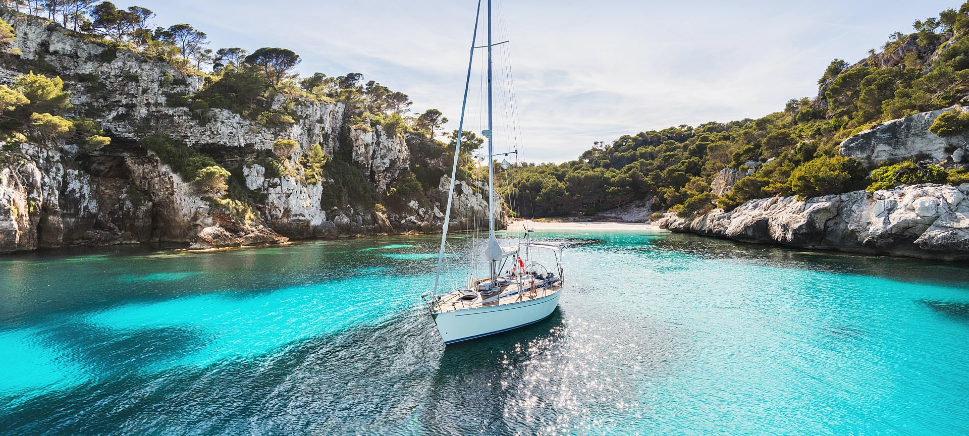 Sailboat in Cala Macarelleta in Menorca, Balearic Islands Sailboat in Cala Macarelleta in Menorca, Balearic Islands