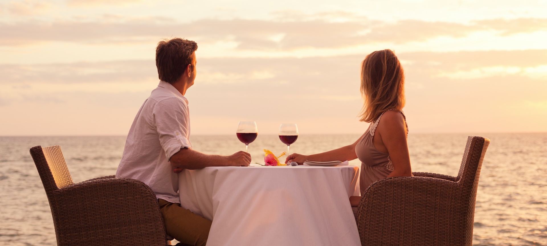 Couple drinking wine by the sea